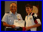 Rafe Corley of TSRA Jrs receiving a Certificate of Achievement for his Third Place finish in the Junior President's Pistol Match (.22)